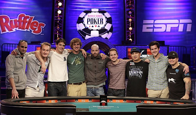 The nine remaining players who will make up the Final Table in November for the World Series of Poker pose for a photo Tuesday, in Las Vegas. From left, they are, Sylvain Loosli, Michiel Brummelhuis, Mark Newhouse, Ryan Riess, Amir Lehavot, Marc McLaughlin, J.C. Tran, David Benefield and Jay Farber. Tran went head to head with Carlos Mortensen to take the final spot. 