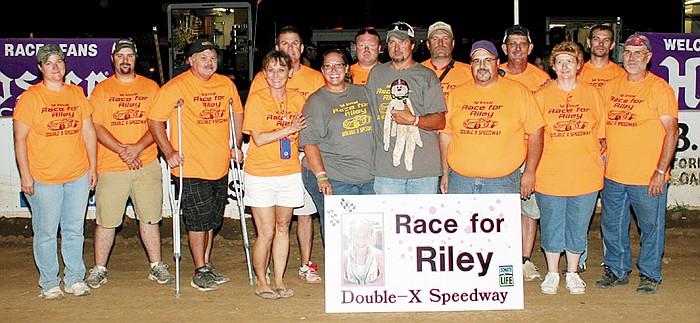 Members of the Double-X Speedway weekly work crew (wearing orange "Riley shirts" in support of Riley Hudson and her parents Tara and Jim Hudson at the Riley Hudson Memorial Races Sunday night at the Double-X) gathered with the Hudsons. Front row, from left, are Carol Wirts, Tara and Jim Hudson, Dean Reichel, Linda and Glen Burlingame; back row, Barb Whittle, Cody Kunze, Roy Wood, Mike Staton, Chris Winter, Todd Melling, Kyle Wirts and Andy Korte.