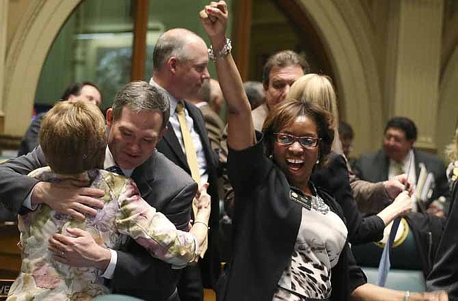  This May 8, 2013 file photo shows Rep. Rhonda Fields, right, pumping her fist at the conclusion of the legislative session in the House chambers. Fields was responsible for gun control laws being passed in Colorado. 