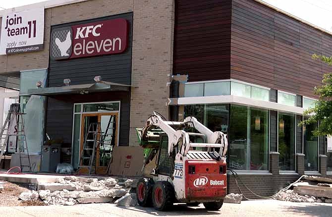 A KFC restaurant that is remodeled on Wednesday, July 17, 2013, in Louisville, Ky. The KFC restaurant is a new test restaurant, called "KFC eleven" and the sign will include no pictures of Colonel Sanders. It will serve flatbread sandwiches, rice bowls and boneless chicken.