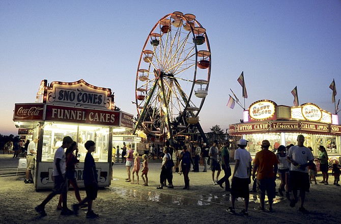 This file photo from July 2011 shows visitors strolling the carnival midway at the Jefferson City Jaycees Cole County Fair.