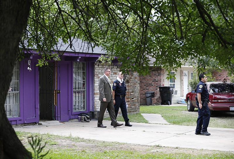 Authorities investigate a home Friday in Houston where police say four homeless men were found in deplorable conditions. Officers who responded to a call expressing concern said they found three men locked in a garage and a fourth in the home who were malnourished and may have been held so a captor could cash checks the men were receiving.