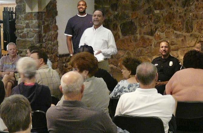 Jefferson City 5th Ward Councilmen Larry Henry (standing, rear) and Ralph Bray meet with area residents Saturday at the McClung Park Pavilion.