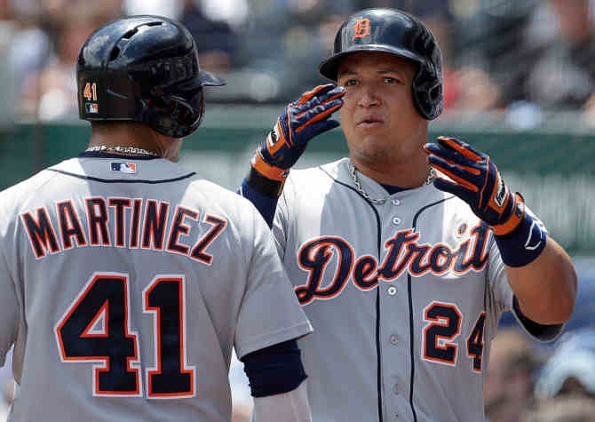 Detroit Tigers' Miguel Cabrera (24) celebrates with teammate Victor Martinez (41) after hitting a solo home run during the first inning of a baseball game against the Kansas City Royals, Sunday, July 21, 2013, in Kansas City, Mo. 