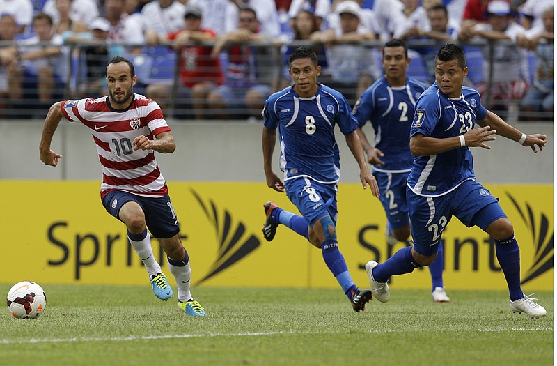 Landon Donovan (10) of the United States races away from El Salvador's Osael Romero Castillo (8), Xavier Garcia Orellana (2) and Mardoqueo Henriquez Dubon (23) during the first half of Sunday's CONCACAF Gold Cup game in Baltimore.