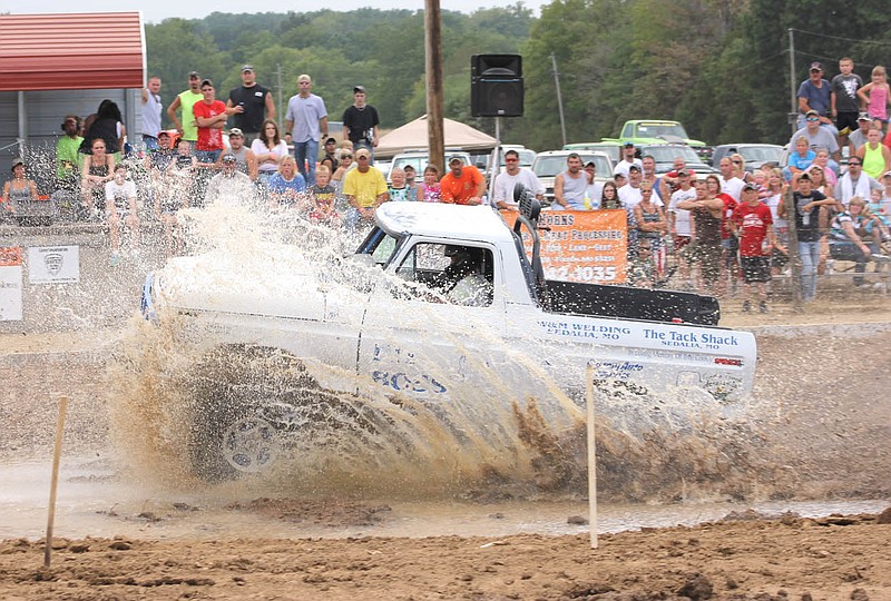 A truck splashes its way through the track during last year's Kingdom of Callaway County Fair's inaugural mud bog. The bog returns this year, alongside several "new" events that herald back to the old-fashioned country fair days. The 2013 fair will run from July 29 to Aug. 3.