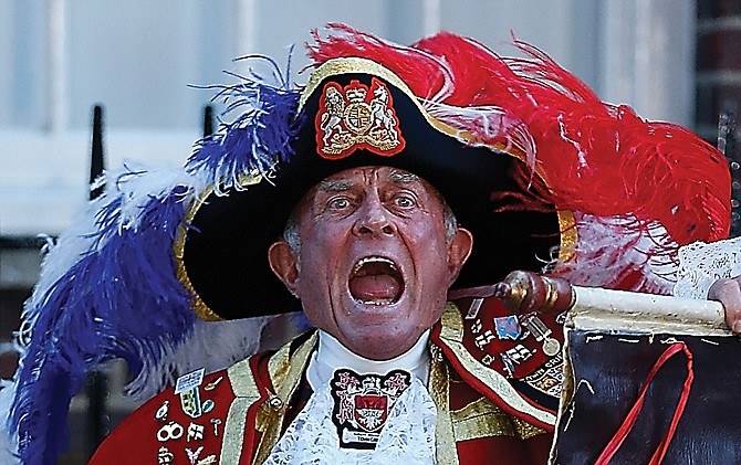 Tony Appleton, a town crier, announces the birth of the royal baby, outside St. Mary's Hospital in London.