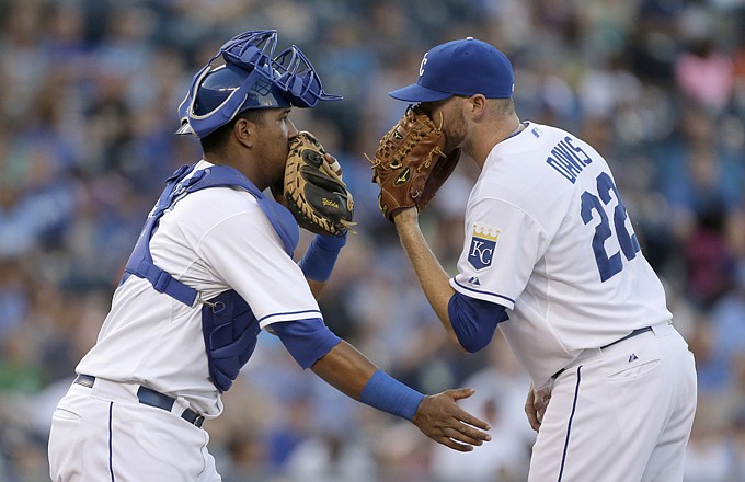 Royals catcher Salvador Perez and starting pitcher Wade Davis meet at the mound after the Orioles loaded the bases in the second inning of Monday night's game at Kauffman Stadium.