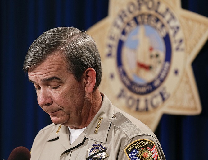 Clark County Sheriff Doug Gillespie gives details about the death of search and rescue police officer David Vanbuskirk during a news conference Tuesday in Las Vegas. Vanbuskirk fell to his death Monday night while rescuing a hiker who was stranded in a forbidden area of Mount Charleston northwest of the city. 