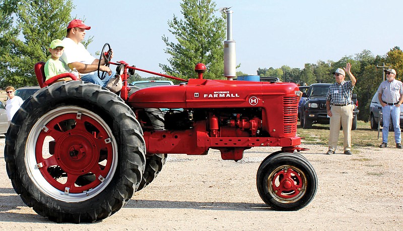 Adam Elley and his 9-year-old son Seth of Mokane ride an International Harvester-McCormick Deering Farmall H tractor during last year's Kingdom of Callaway Historical Society's annual Callaway Vintage Tractor Drive. This year's event starts 9:30 a.m. Aug. 24 at the New Bloomfield Lions Club Park.
