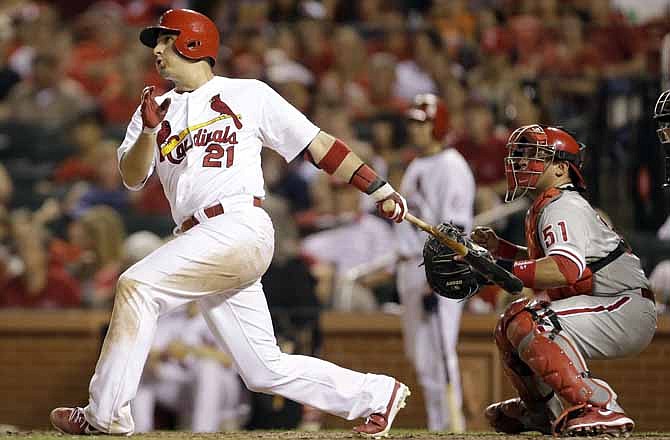 St. Louis Cardinals' Allen Craig hits an RBI-single as Philadelphia Phillies catcher Carlos Ruiz, right, watches during the seventh inning of a baseball game on Tuesday, July 23, 2013, in St. Louis.