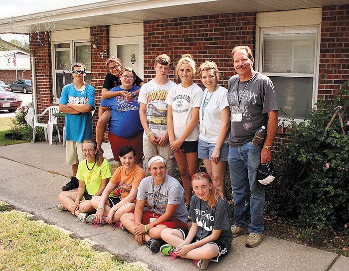 Volunteers with the 3MT Lifechangers doing clean-up and repairs at the Senior Housing job site in California July 16 take a break to cool off. Site leaders for the group, in the back row, far right, are Kim Johnson with Main Street Baptist Church in California, and Dinzel Webb with Russellville Baptist Church. The group of missionaries at this job site consisted of local volunteers, as well as some from as far away as Sedalia, Shawnee, Kan., and St. Louis. 