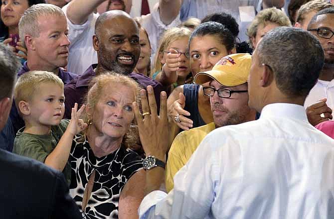 Dallas Muller-Ayers, age 3, held by his grandmother Diana Duley, shows President Barack Obama his age following Obama's speech at the University of Central Missouri in Warrensburg, Mo., Wednesday, July 24, 2013. Obama hit the road to deliver remarks in Illinois and Missouri kicking off a series of speeches that lay out his vision for rebuilding the economy. 