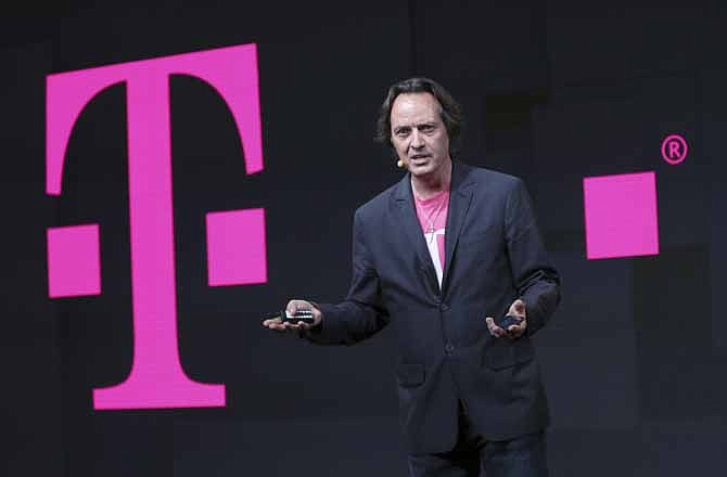 T-Mobile CEO John Legere speaks during news conference, Wednesday, July 10, 2013 in New York. T-Mobile says it will let people upgrade phones more quickly for a $10 monthly fee. With the new Jump plan, a customer will be able to get a new phone if the old one malfunctions or gets lost, or even if there's a better phone that comes out. The plan lets customers upgrade up to twice a year. Rivals typically allow upgrades after about two years.