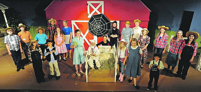 Cast members from Stained Glass Theatre's production of "Charlotte's Web" pose on stage.