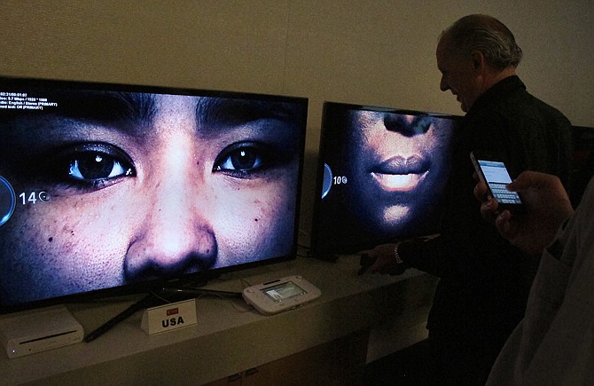 Employees view the debut of the new series "Orange is the new black" at Netflix headquarters in Los Gatos, Calif.