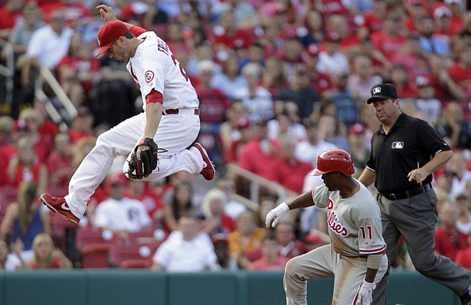 Cardinals third baseman David Freese leaps out of the way after stepping on third to force out the Phillies' Jimmy Rollins (11) in the third inning Thursday in St. Louis. 