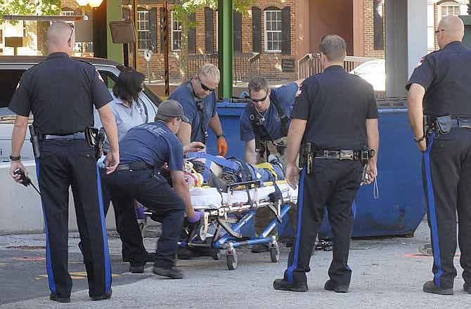 Police, fire and medical personnel responded to downtown Jefferson City late Saturday afternoon after a man dropped from the Capitol Street Parking Garage to the parking lot below.