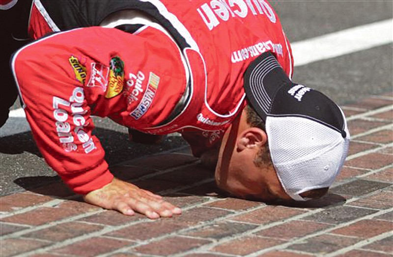 Ryan Newman kisses the yard of bricks after winning the Brickyard 400 on Sunday at Indianapolis Motor Speedway.