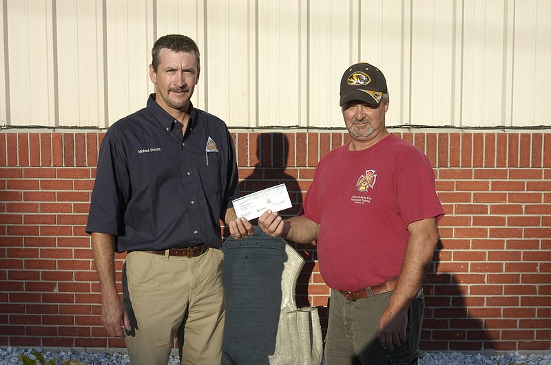 Democrat photo / David A. Wilson
Michael Schulte, Missouri Department of Conservation, presents a check to Steve Walters for California Rural Fire Protection District for the matching grant of $3,000 for purchase of a 200 gallon water tank to be mounted on a pickup.  