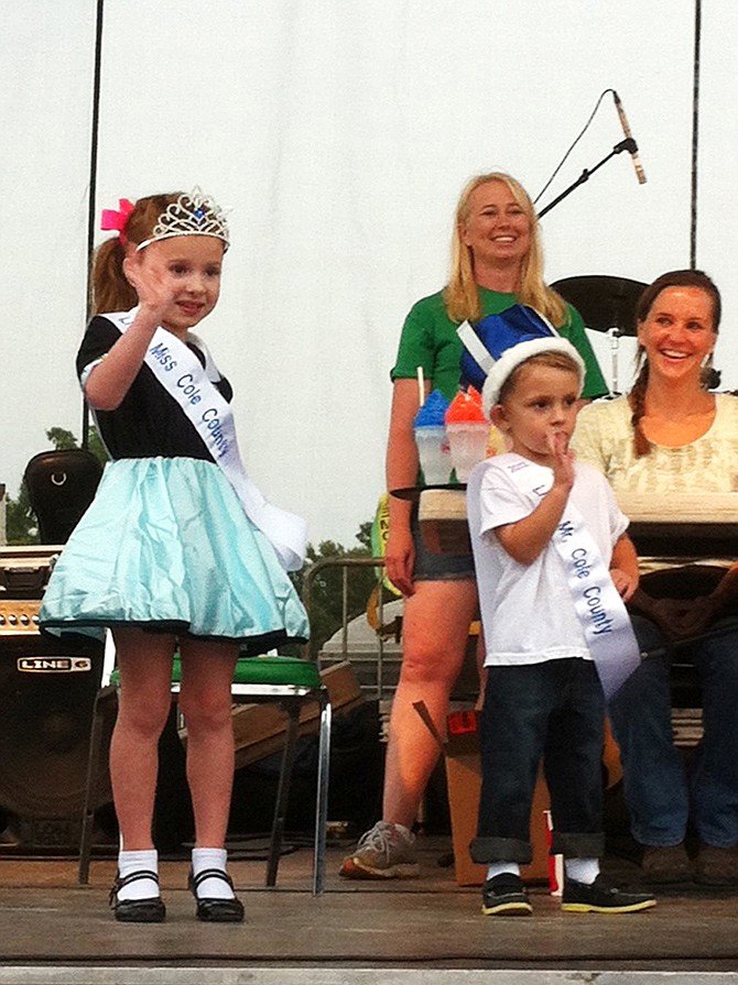 Little Miss Cole County 2013 Reese Michelle Denich, age 41â„2, and Little Mr. Cole County Mason Dishman, age 3, wave to the crowd after being crowned Monday night at the fair.
