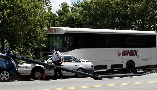 An officer works on the scene of a bus accident in West New York, N.J., Tuesday. Authorities in northern New Jersey say a baby has died in a freak accident involving a shuttle bus and a lamppost.