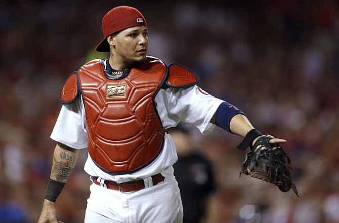 In this June 21, 2013, photo, St. Louis Cardinals catcher Yadier Molina gestures after the top of the sixth inning of a baseball game against the Texas Rangers in St. Louis. 