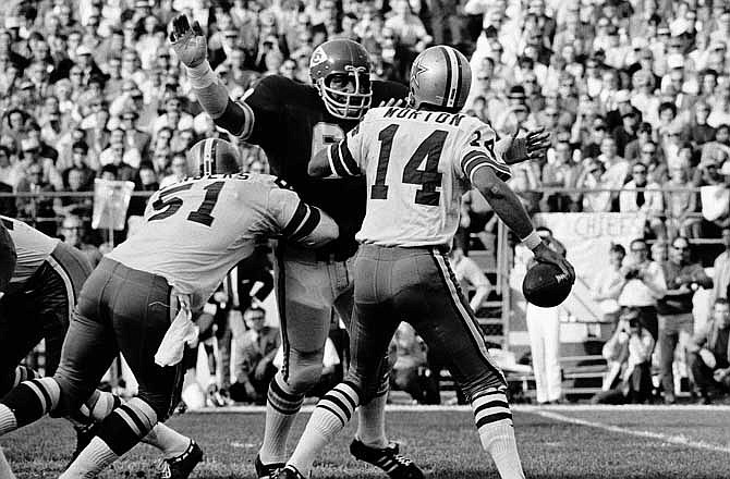 In this Oct. 26, 1970 file photo, Kansas City's Curley Culp, rear, defends as Dallas quarterback Craig Morton (14) tries to pass during a football game in Kansas City, Mo. Culp will be inducted into the Pro Football Hall of Fame on Saturday, Aug. 3, 2013 in Canton, Ohio.