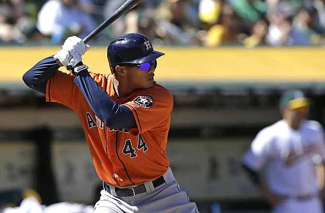 In this April 17, 2013, photo, Houston Astros' Justin Maxwell bats against the Oakland Athletics during a baseball game in Oakland, Calif. With an eye on the postseason for the first time in a decade, the Kansas City Royals traded minor league pitcher Kyle Smith to the Astros to acquire the speedy Maxwell, giving them a right-handed bat to help balance out the lineup for the stretch run.