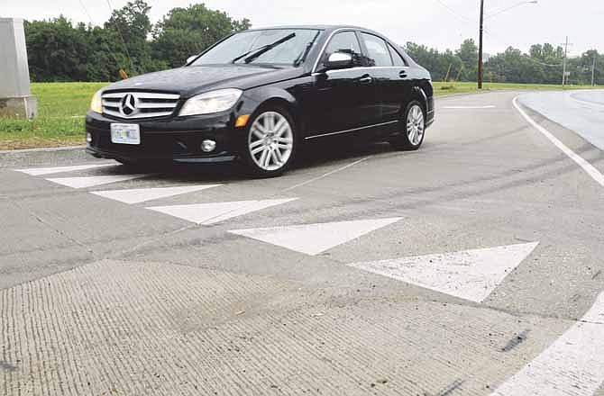 A car makes a right turn Tuesday morning using the newly constructed lane on Stadium Boulevard at Edgewood Drive in Jefferson City.