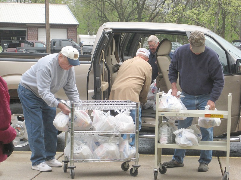 Volunteers with the Callaway Buddy Pack program sort food to be sent home with area students. Program organizers say they still need $27,000 to fully fund the program for this school year.