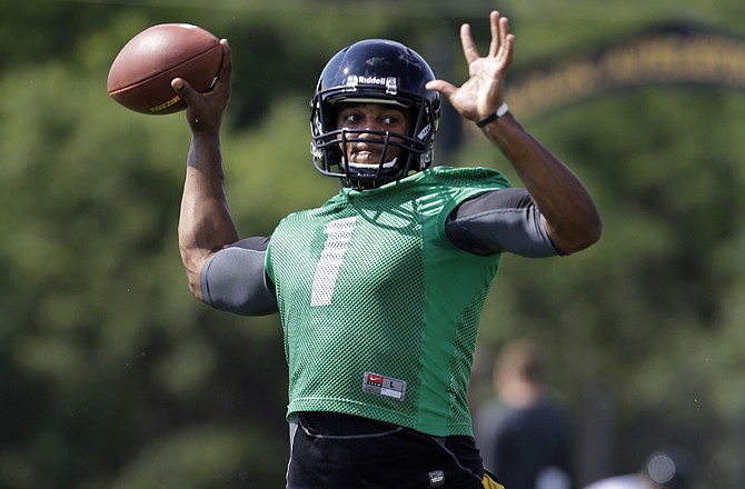 Missouri quarterback James Franklin prepares to pass Thursday in Columbia during the Tigers' first practice of the season.