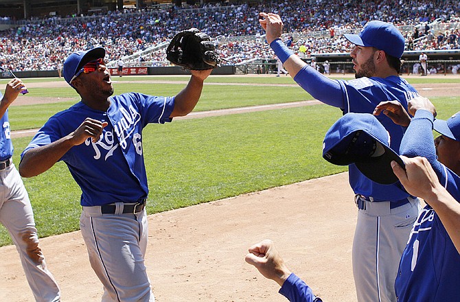 Royals center fielder Lorenzo Cain celebrates with teammates after robbing the Twins' Trevor Plouffe of a home run in the fifth inning of Thursday's game in Minneapolis.