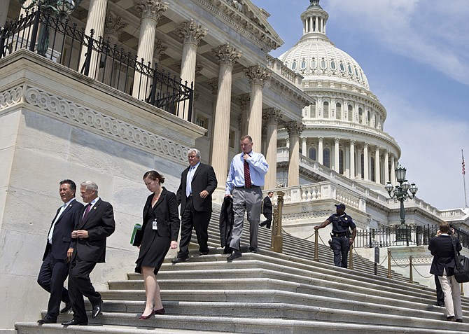 After final votes were cast, members of Congress walk down the steps of the House of Representatives on Capitol Hill in Washington on Friday, as they leave for a five-week recess. With few accomplishments in the divided 113th Congress, the next big battle is over the budget, the nation's debt limit and the possibility of at least a partial government shutdown. 