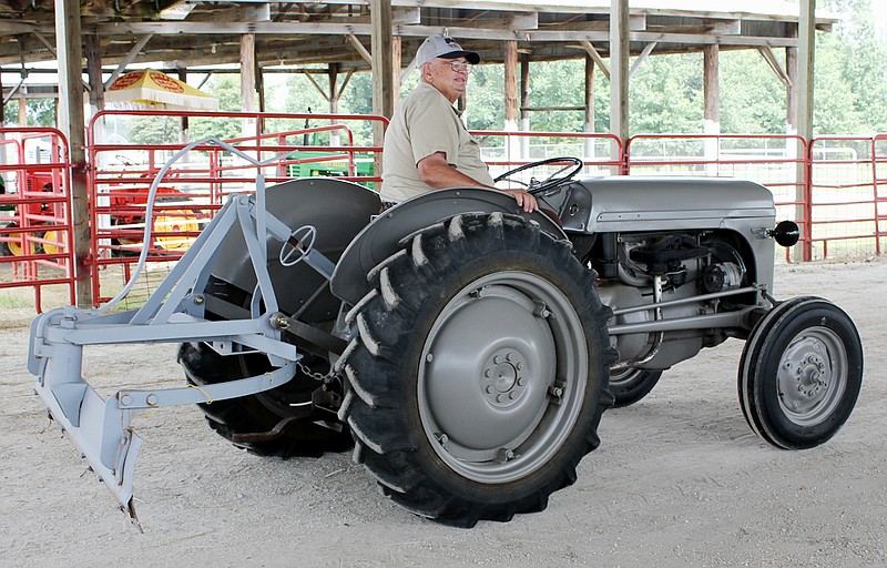 Former Callaway County Commissioner Rodney Garnett displays a 1947 TE-20 Ferguson tractor equipped with a Carrington terracing blade invented and patented by George Carrington of Fulton and manufactured for a time by Danuser Equipment Co. of Fulton. The Ferguson tractor was made in England prior to a brief merger between Ferguson and Ford Motor Co.