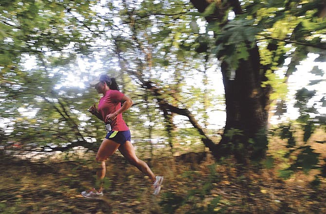 A runner makes her way through one last wooded stretch as she approaches the finish line while competing in the 2012 Jefferson City Rotaract Club "Kicks In The Sticks" Trail Scramble at Binder Park.