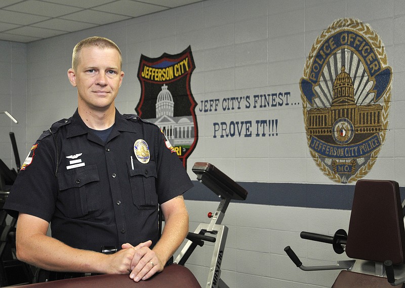 Officer Andy Lenart poses for portrait at the Jefferson City Police station. After visiting Jefferson City in the mid-1990's, after his discharge from the U.S. Navy, he moved to this area to start his civilian life.