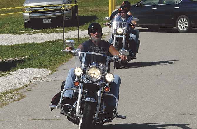 Jack Huddleston, foreground, and Jason Besche and Karen McDaneld returned first to the Jefferson City Jaycees Fairgrounds Saturday, ending a 160-mile Poker Run raising money for two Mid-Missouri charities.