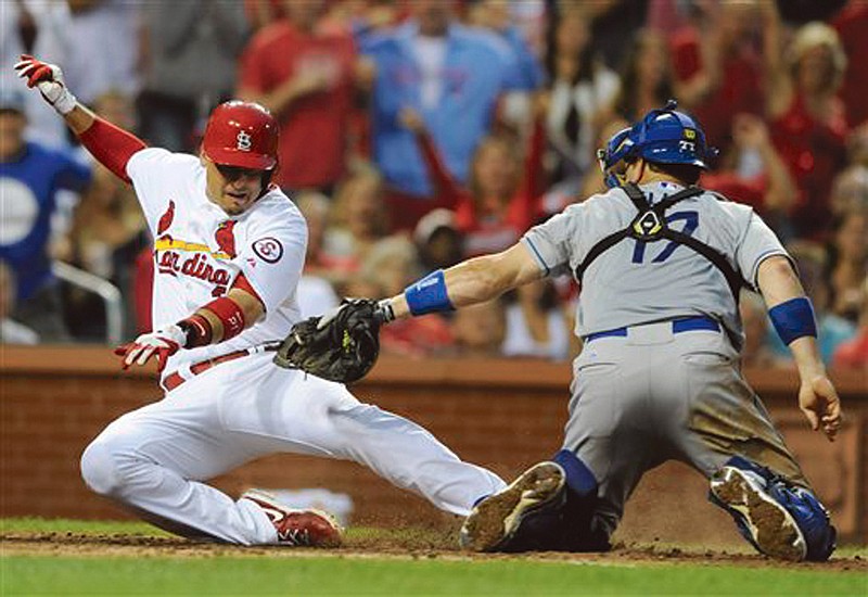 The Cardinals' Allen Craig is tagged out at home by by Dodgers catcher A.J. Ellis in the fifth inning of Monday's game at Busch Stadium.