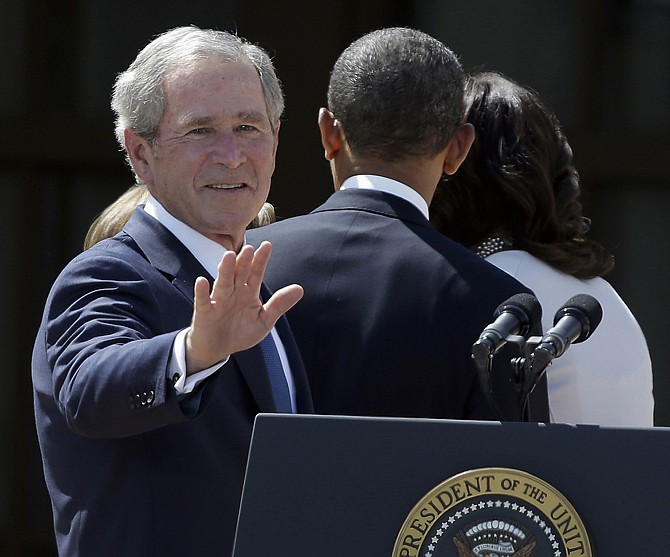 President George W. Bush turns to wave as he leaves with President Barack Obama and first lady Michelle Obama after the dedication of the George W. Bush Presidential Center in Dallas. Bush has successfully undergone a heart procedure after doctors discovered a blockage in an artery. 