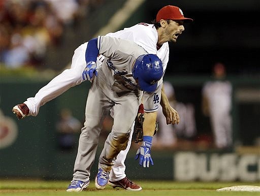 Cardinals second baseman Matt Carpenter (top) fails to turn the double play as he gets tangled up with the Dodgers' Nick Punto during the seventh inning Tuesday  in St. Louis.