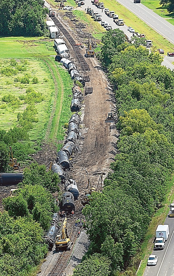 Railroad repair crews work to repair 1,800 feet of track after an eastbound train derailed just east of Lawtell, La.
