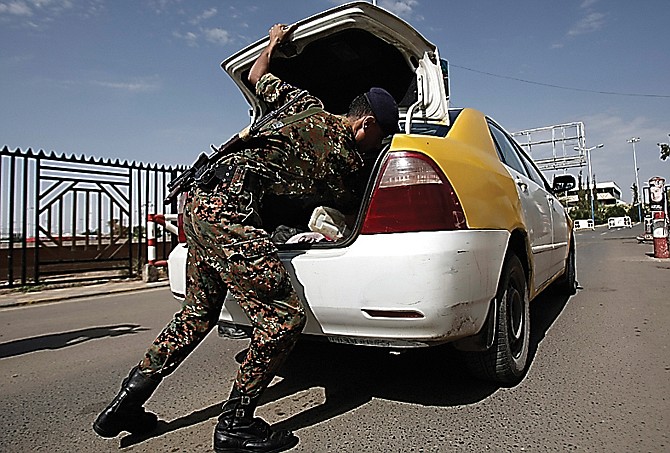 A policeman checks a car at the entrance of Sanaa International Airport in Yemen. Authorities have foiled plots by al-Qaida to take over key cities in southern Yemen and attack strategic ports and gas facilities.