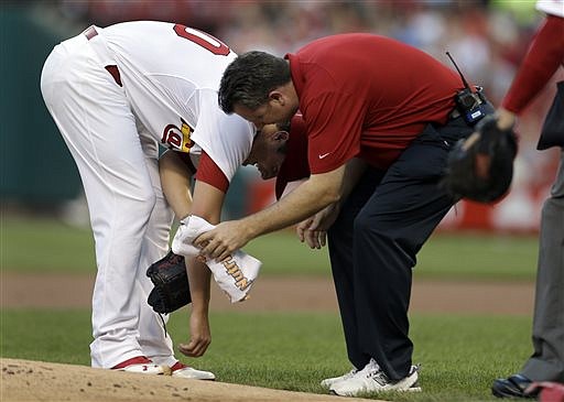 Cardinals starting pitcher Shelby Miller is checked on by trainer Chris Conroy after being struck by a ball hit by the Dodgers' Carl Crawford during the first inning Wednesday in St. Louis. The pitch was the second of the game and Miller was forced to leave the contest.