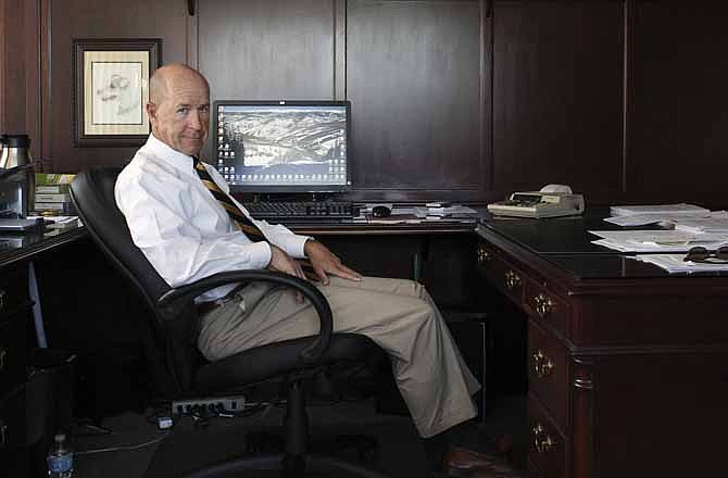 In this July 23, 2013 photo, Mike Shoop, owner of a debt collection agency, sits for a portrait inside his office at Professional Finance Company, in Greeley, Colo. Shoop says his company may have to cut back on coverage for employees if they can't afford insurance under President Obama's new healthcare law. 