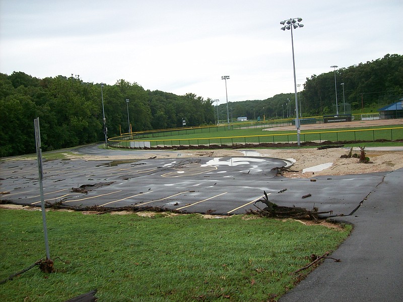 Flooding for the Osage Beach City Park's pond washed out underneath the parking lot's pavement and debris destroyed the black top. This parking lot, which was installed last year, cost the city about $80,000.