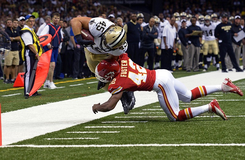 Saints fullback Jed Collins is knocked out of bounds near the goal line by Otha Foster of the Chiefs during the second half of Friday night's game in New Orleans.