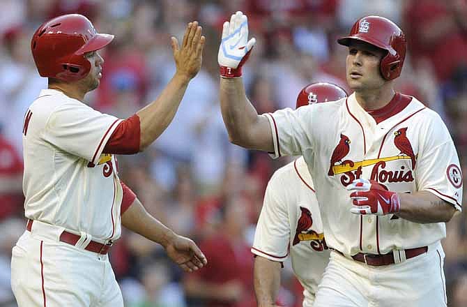 St. Louis Cardinals' Matt Holliday, right, is congratulated by Carlos Beltran, left, after his three-run home run against the Chicago Cubs in the fourth inning of a baseball game Saturday, Aug. 10, 2013, at Busch Stadium in St. Louis. 