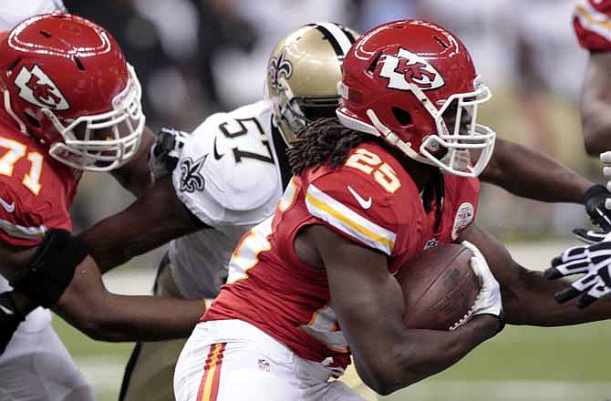 Kansas City Chiefs running back Jamaal Charles (25) carries past New Orleans Saints outside linebacker David Hawthorne (57) during the first half of an NFL preseason football game at the Superdome in New Orleans, Friday, Aug. 9, 2013.