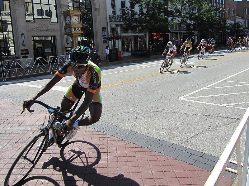 Riders approach a turn in the .85-mile loop course of Sunday's Missouri State Criterium Championships downtown. The annual race draws some of the top cyclists around, including some professional racers. Below, racers in the women's open division leave the Capitol grounds section of the course.